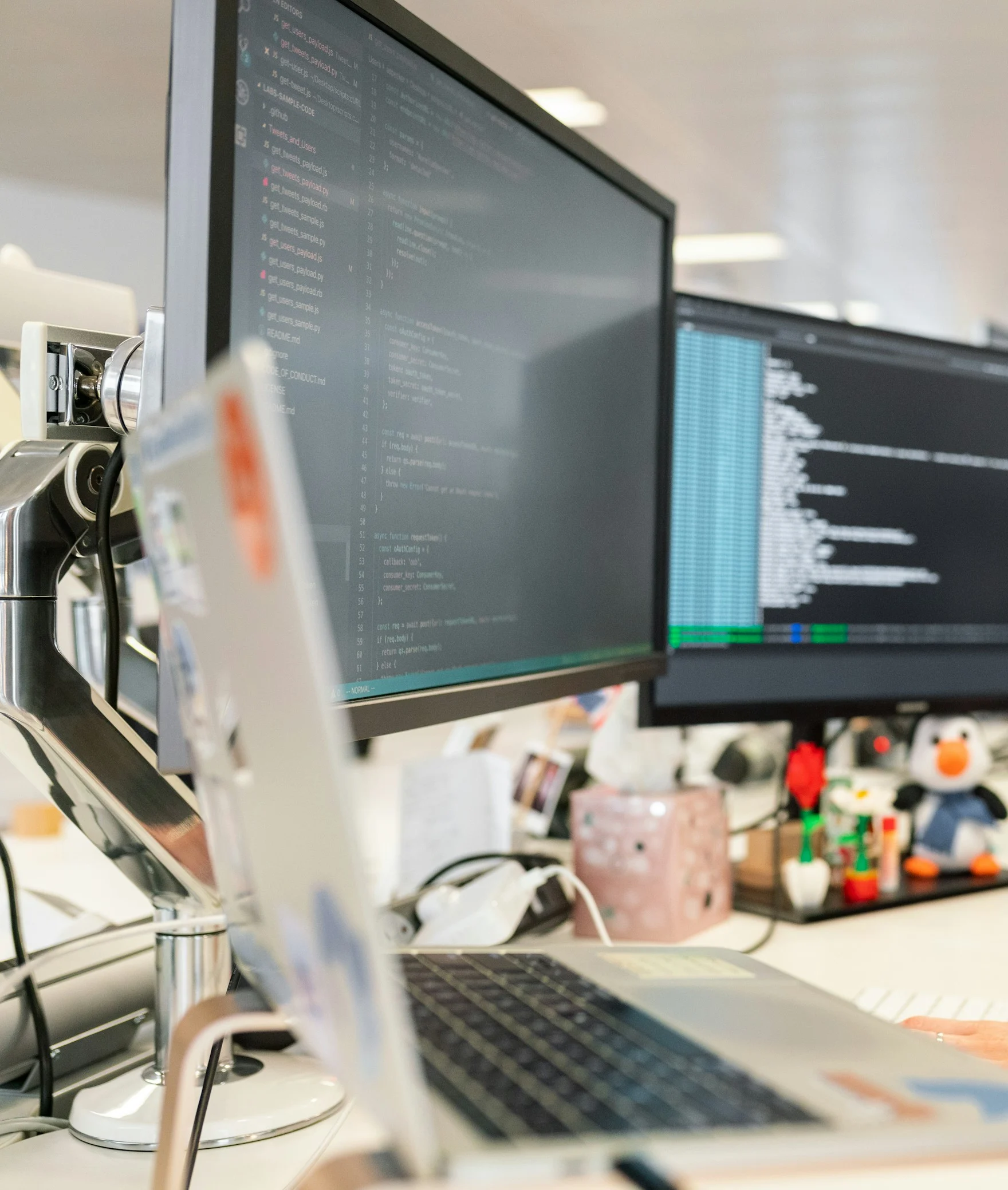 A developer workstation with code on two monitors