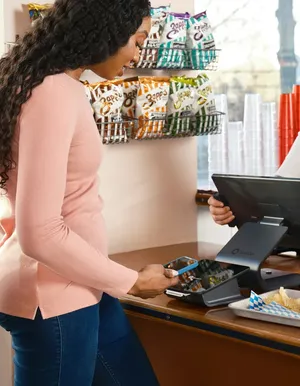 Customer paying at a point-of-sale counter