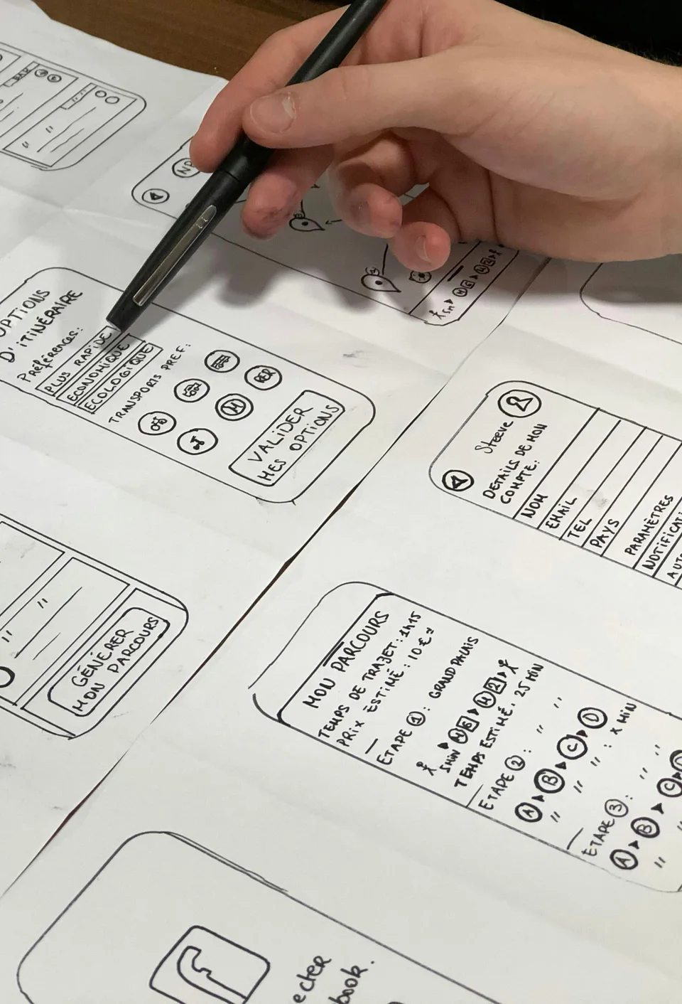 Hand sketching app prototype screens on paper